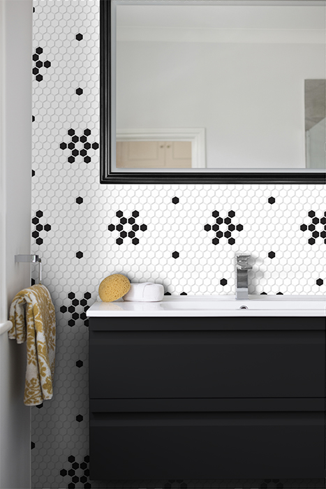 A modern and clean bathroom sink, mirror, sponge and towel